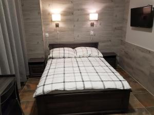 a bedroom with a bed with two pillows on it at Marcus in Bydgoszcz