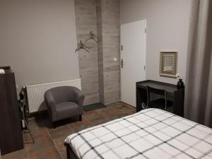 a bedroom with a bed and a desk and a chair at Marcus in Bydgoszcz