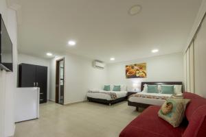 a large room with two beds and a couch at Providence Breeze in San Andrés