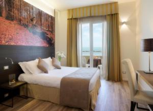 a hotel room with a bed and a window at Hotel Life in Rimini