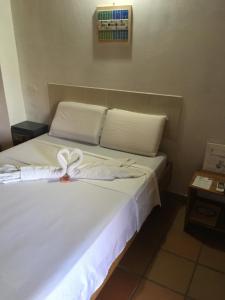 Hotel Pizzeria Opera Tolú客房内的一张或多张床位