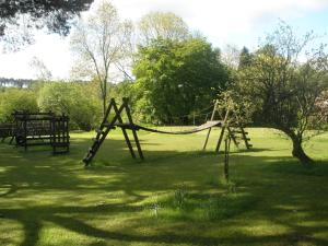 a park with a swing set in the grass at Lastingham Grange in Lastingham