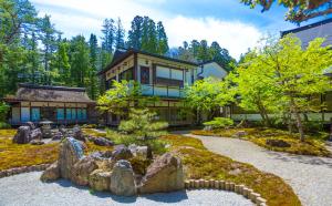 a large house with a garden in front of it at Sojiin in Koyasan