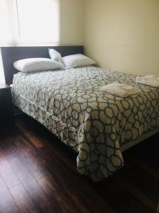 a bedroom with a bed with two pillows on it at A Room for You! in Atlanta