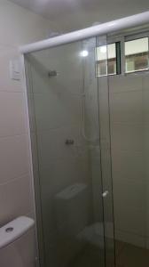 a glass shower in a bathroom with a toilet at FLAT EM INTERMARES in Cabedelo