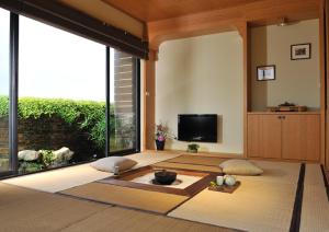 a living room with a large window and a tv at Posia 122 in Tainan