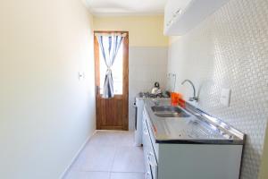 a kitchen with a sink and a counter top at Aparts Dunas de Valizas in Barra de Valizas