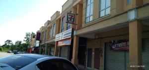 a car parked in front of a building on a street at Homestay Simple in Gambang