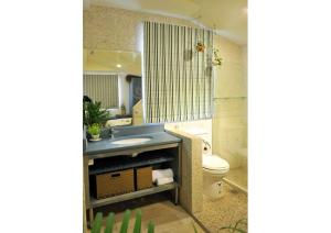 a bathroom with a sink and a toilet at Posia 122 in Tainan +63 photos