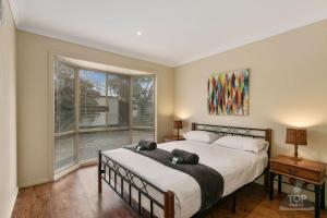 a bedroom with a bed and a large window at Yarram Holiday Park in Yarram +42 photos