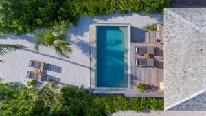an overhead view of a swimming pool next to a building at Hurawalhi Island Resort in Kuredu