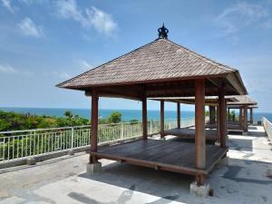 a gazebo with a roof on top of a building at Balangan Paradise Hostel and Restaurant in Jimbaran