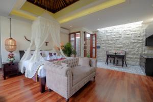 a bedroom with a bed and a couch and a table at Villa Bougainville in Seminyak +38 photos