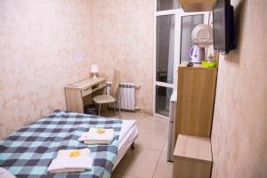 a small room with a bed and a desk in it at Bolshaya Morskaya 7 in Saint Petersburg