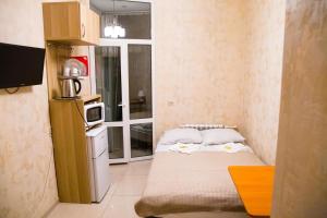 a small kitchen with a small bed in a room at Bolshaya Morskaya 7 in Saint Petersburg