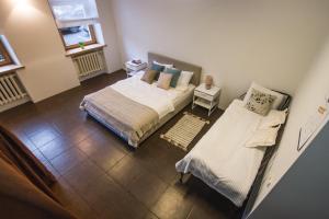 a bedroom with two beds and a window at SPACIOUS 3 ROOM CENTRAL APARTMENT 56d in Kaunas
