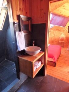 a bathroom with a sink and a shower at Dune & Domes Pichilemu in Pichilemu