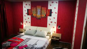 a bedroom with a bed with red walls and red walls at CoquetteHouse Cotroceni Palace in Bucharest