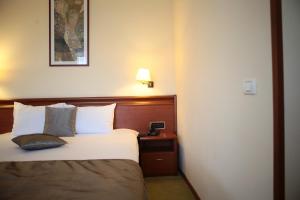 Postel nebo postele na pokoji v ubytování Savoy Hotel