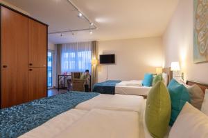 a hotel room with two beds and a tv at Princess No3 Self Check-In Plochingen bei Stuttgart in Plochingen +124 photos