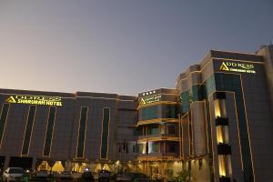 a large building with a sign on the front of it at Address Sharurah Hotel in Sharurah