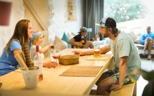 a group of people sitting at a table at Wellenkind Surfschool in La Pared