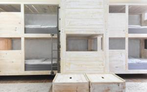 a set of wooden bunk beds in a room at Wellenkind Surfschool in La Pared