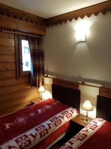 a bedroom with two beds and a window at La Ginabelle Gala in Chamonix-Mont-Blanc
