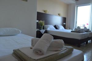Postel nebo postele na pokoji v ubytování Hotel Achillion