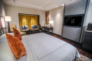 a hotel room with a bed and a television at Taj Coromandel in Chennai