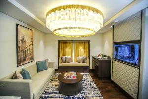 a living room with a couch and a chandelier at Taj Coromandel in Chennai