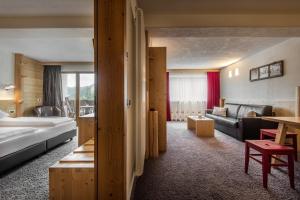 A bed or beds in a room at Hotel Gran Ciasa
