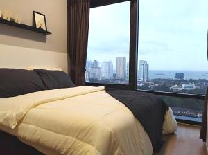 a bedroom with a bed and a large window at Georgetown SeaView Condo Tropicana 218 Macalister in George Town