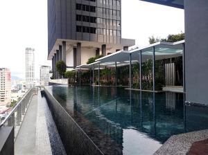 a swimming pool on the side of a building at Georgetown SeaView Condo Tropicana 218 Macalister in George Town +24 photos