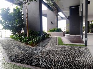 an office lobby with a gravel path and trees at Georgetown SeaView Condo Tropicana 218 Macalister in George Town