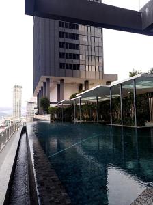 a swimming pool in front of a building at Georgetown SeaView Condo Tropicana 218 Macalister in George Town