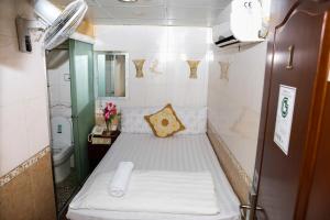 a small room with a bed in a bathroom at Everest Hostel 14/F in Hong Kong