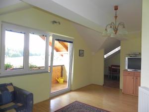 a living room with a couch and a tv at Apartments Kleinseeblick in Sankt Kanzian
