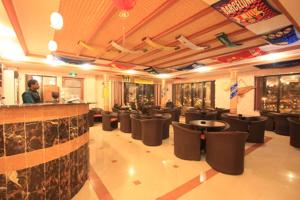 a restaurant with a lot of chairs and a bar at Abha Hotel in Abha