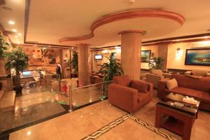 a lobby with couches and chairs in a building at Abha Hotel in Abha