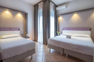 Postel nebo postele na pokoji v ubytování Hotel Palace