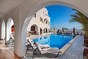 a view of a swimming pool in a villa at Astir Thira Hotel in Fira