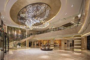 a large lobby with a chandelier in a building at Wyndham Shanghai Nanxiang in Jiading