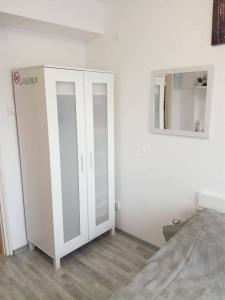 a room with a white cabinet and a mirror at Ruby room in Zagreb