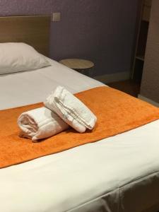 Postel nebo postele na pokoji v ubytování Hotel de Bretagne