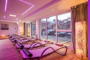 a row of pilates chairs in a room with windows at Hotel Landhaus Zillertal in Fügen
