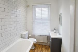 a white bathroom with a toilet and a sink at Host & Stay - Windsor Cottage in Saltburn-by-the-Sea