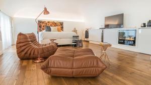 a bedroom with a bed and a couch and a chair at MiHotel Comte in Lyon