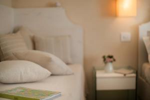 A bed or beds in a room at Dimora Sighé, exclusive rural villa with hydromassage pool