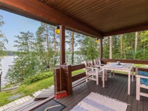 VuoriniemiにあるHoliday Home Illanvirkku by Interhomeの木製デッキ(テーブル、椅子付)